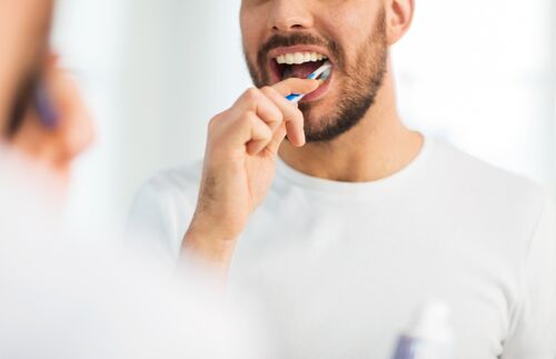 Man tooth brushing