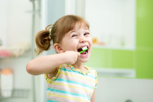 Girl with toothpase and brushing